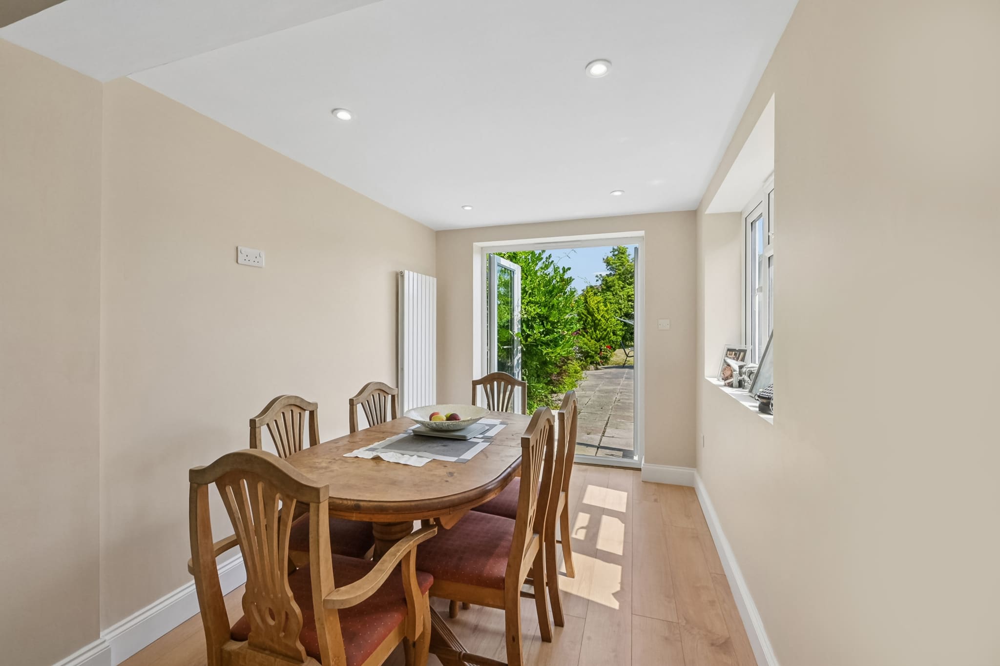 Bright dining area inside a rear extension opening onto the garden, Greenwich