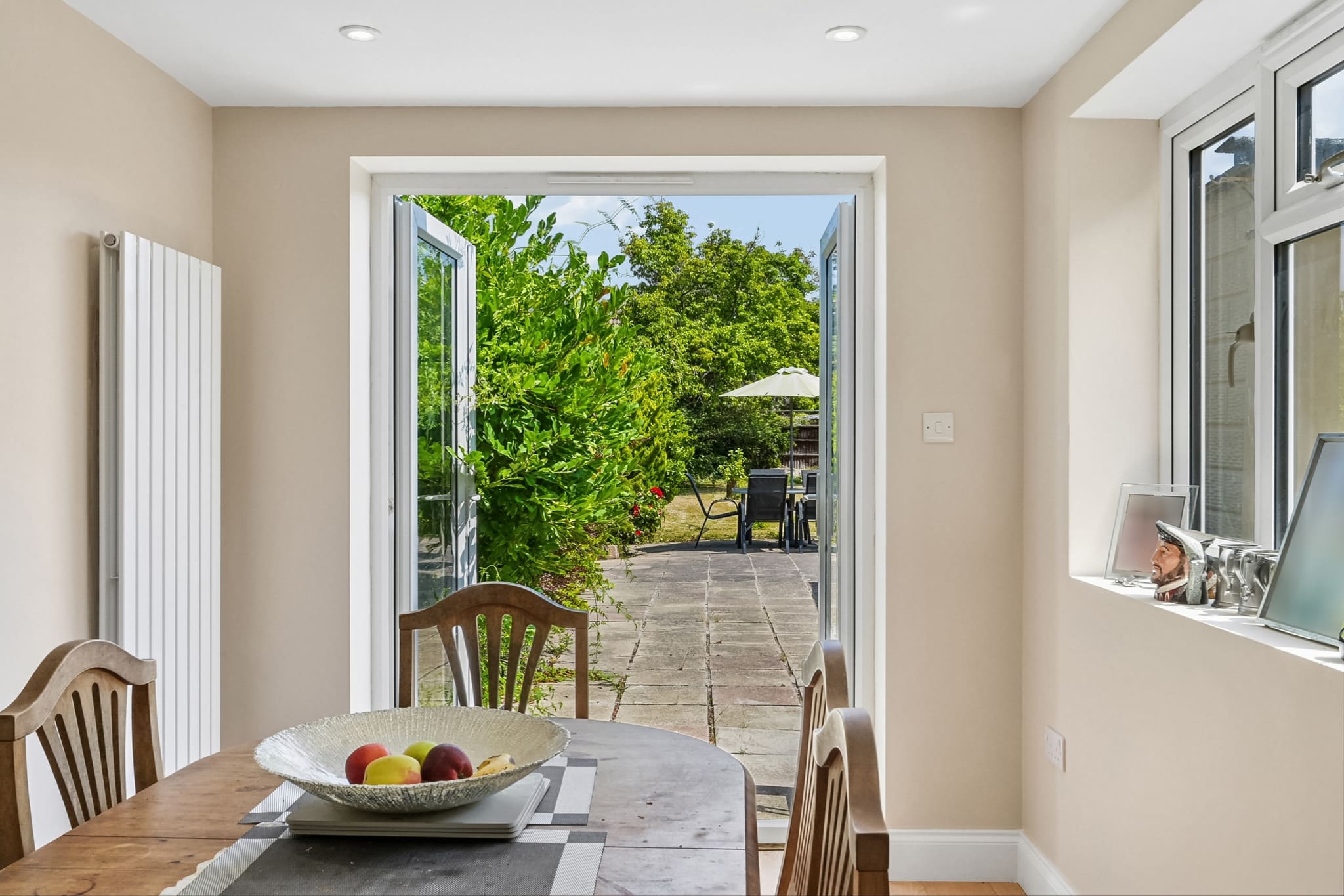 Rear extension dining space with full-height French doors opening onto the garden, Greenwich