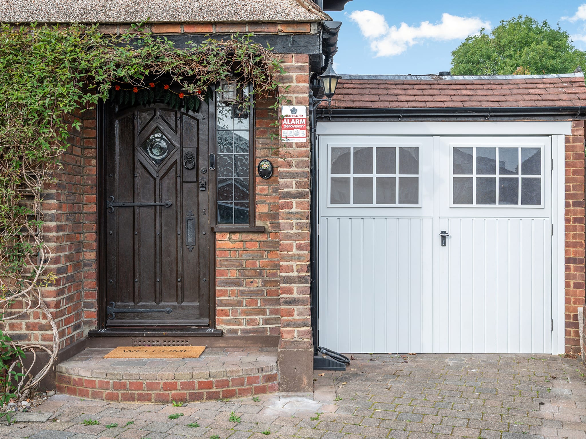 Front entrance and garage of a Surrey home at the start of a pre-purchase visit